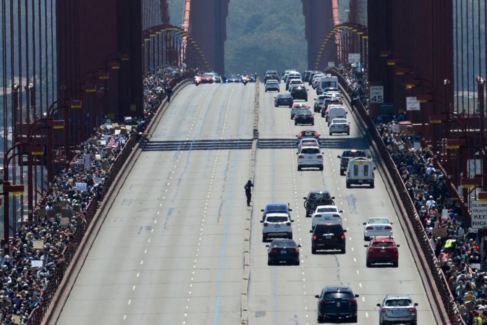 Thousands of demonstrators march across the Golden Gate Bridge in San Francisco, California (REUTERS)