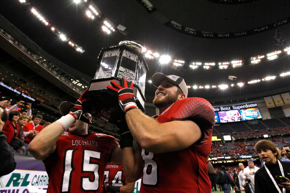 Louisiana-Lafayette wide receiver Ross Goodlett (15) and quarterback Brad McGuire (8) hold up the New Orleans Bowl trophy after their NCAA college football game against San Diego State in New Orleans, Saturday, Dec. 17, 2011.  Louisiana-Lafayette won 32-30. (AP Photo/Gerald Herbert)
