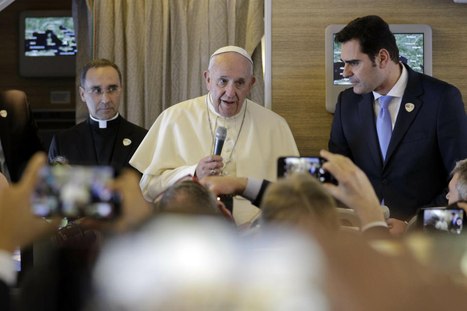 Pope Francis greets journalists aboard an airplane on his way to the United Arab Emirates, Sunday, Feb. 3, 2019. Francis made an urgent appeal for an end to the humanitarian crisis in Yemen on Sunday as he embarked on the first-ever papal trip to the Arabian Peninsula, where he is seeking to turn a page in Christian-Muslim relations while also ministering to a unique, thriving island of Catholicism. (AP Photo/Andrew Medichini)