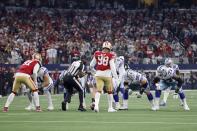 Umpire Ramon George (128) backs away from the line of scrimmage after setting the ball on the final play for the Dallas Cowboys in the second half of an NFL wild-card playoff football game against the San Franciso 49ers in Arlington, Texas, Sunday, Jan. 16, 2022. (AP Photo/Ron Jenkins)