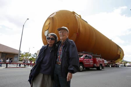 Frank Elston, 93 and Florence Elston, 91, pose for a photo as the space shuttle Endeavour's external fuel tank ET-94 makes its way to the California Science Center in Exposition Park in Los Angeles, California, U.S. May 21, 2016. REUTERS/Lucy Nicholson