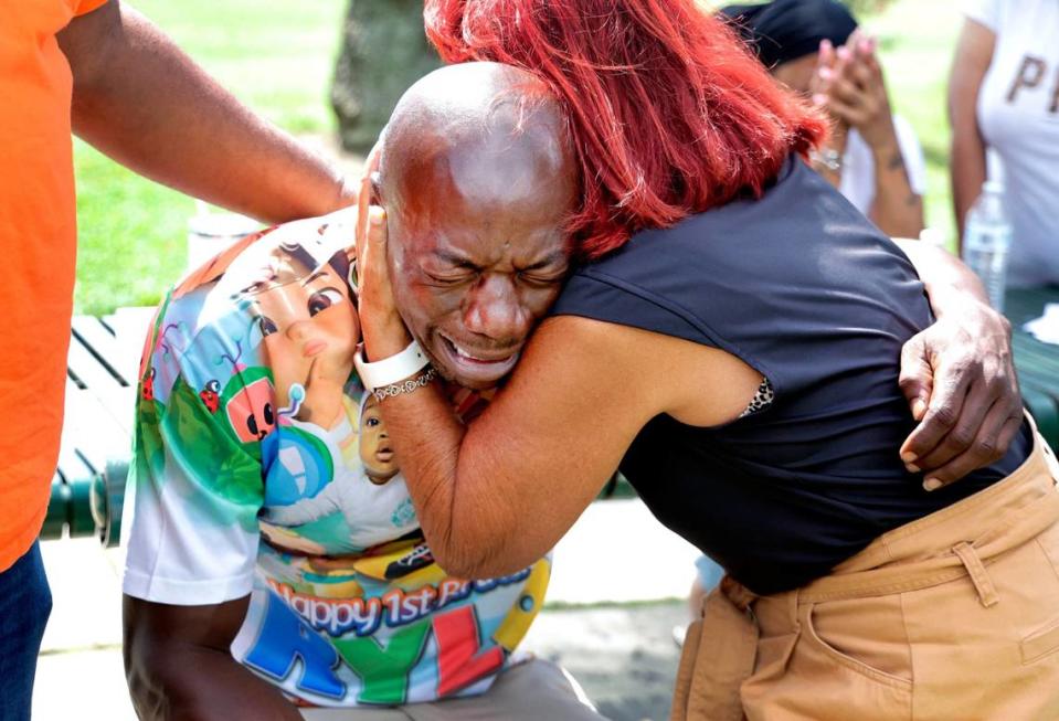 Jerrold Pugh, the grandfather of 3-year-old Rylo Yancy who was killed in a drive-by shooting on Sunday is comforted during a press conference by Fort Lauderdale city officials at Riverland Park in Fort Lauderdale on Wednesday, July 24, 2024. (Carline Jean/South Florida Sun Sentinel)