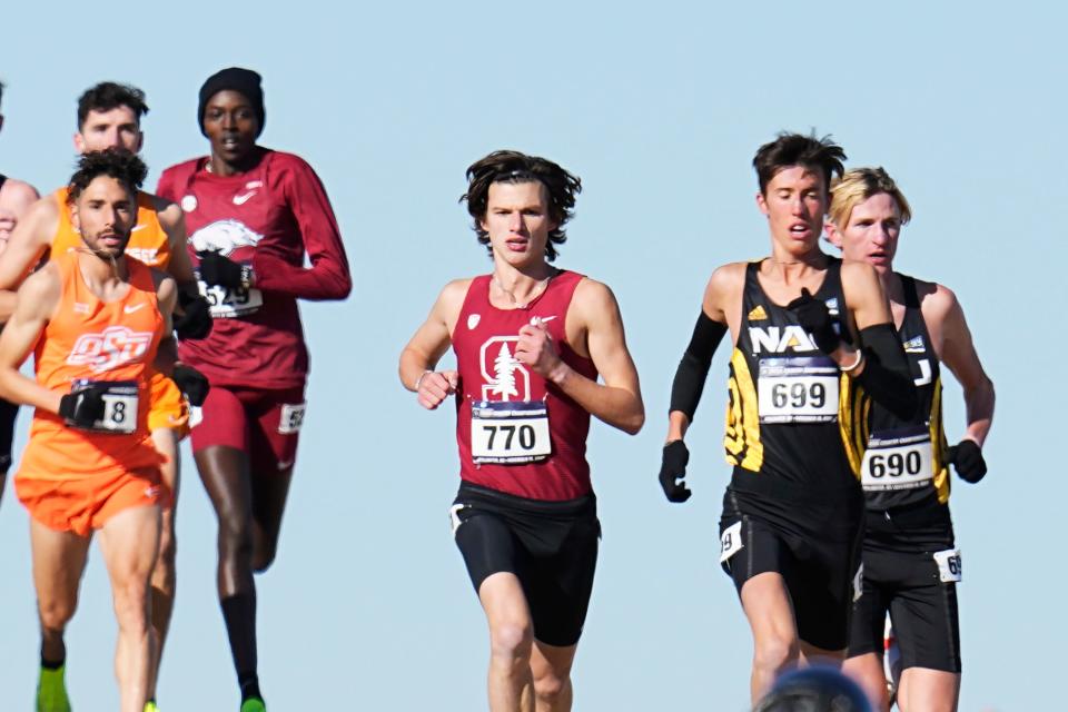 Stanford's Charles Hicks (770), Northern Arizona's Nico Young (699) and Northern Arizona's Drew Bosley (690) lead the pack early in the NCAA Cross Country Championships, Saturday, Nov. 19, 2022, in Stillwater, Okla. (AP Photo/Sue Ogrocki)