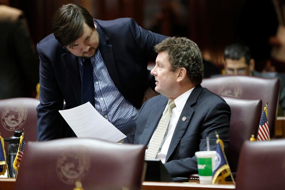 Rep. Jim Lucas talks with a staff member on the last day of legislative session Tuesday, March 8, 2022, at the Indiana Statehouse in Indianapolis. 