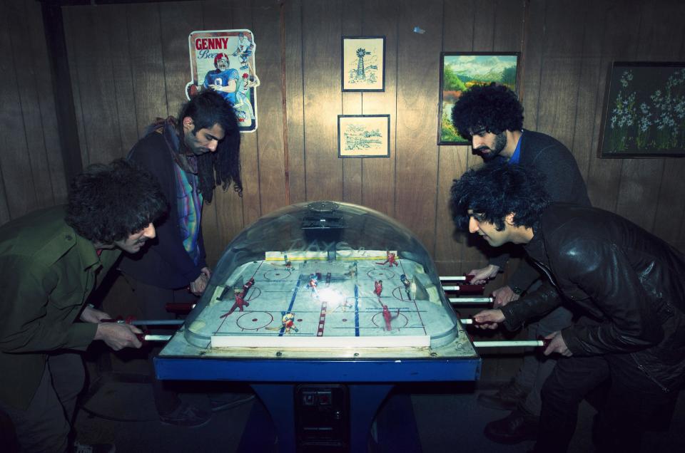 This 2012 photo shows Yellow Dogs band members, from left, Soroush Farazmand, Siavash Karampour, Arash Farazmand and Koroush "Koory" Mirzaei, front, right, are seen at The Gutter in the Brooklyn borough of New York. Police say a musician who shot and killed three other Iranian men inside a New York City apartment before committing suicide was upset because he had been kicked out of an indie rock band. Ali Akbar Mohammadi Rafie gunned down the men just after midnight on Monday, Nov. 11, 2013. Victims Soroush and Arash Farazmand were brothers who played in a band called the Yellow Dogs. The third victim, Ali Eskandarian was also a musician. After the shooting, investigators found a guitar case on a rooftop they believe the shooter may have used to carry the assault rifle used in the attack. (AP Photo/Danny Krug) NO SALES