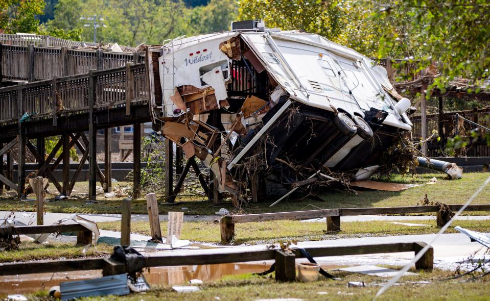 An RV lies wedged into the pedestrian bridge in Carrier Park in Asheville Wednesday afternoon.