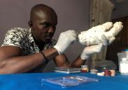 John Amanam works on a prosthetic hand at his company in Uyo