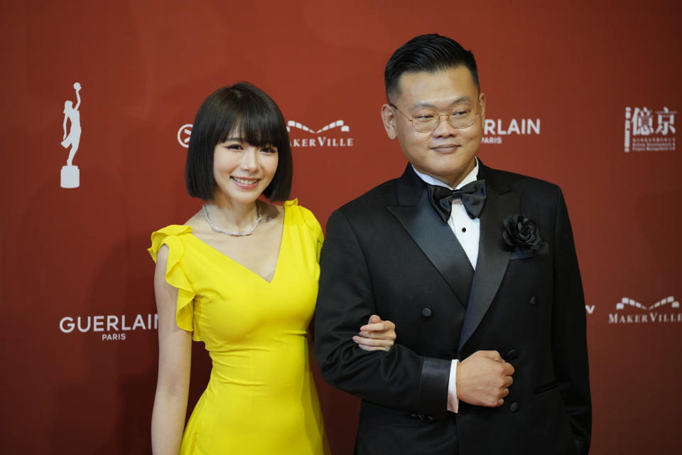 Hong Kong actor Michael Ning, right, and Malaysia actress Lin Min-chen pose on red carpet at the Hong Kong Film Awards, Sunday, July 17, 2022. (AP Photo/Kin Cheung)