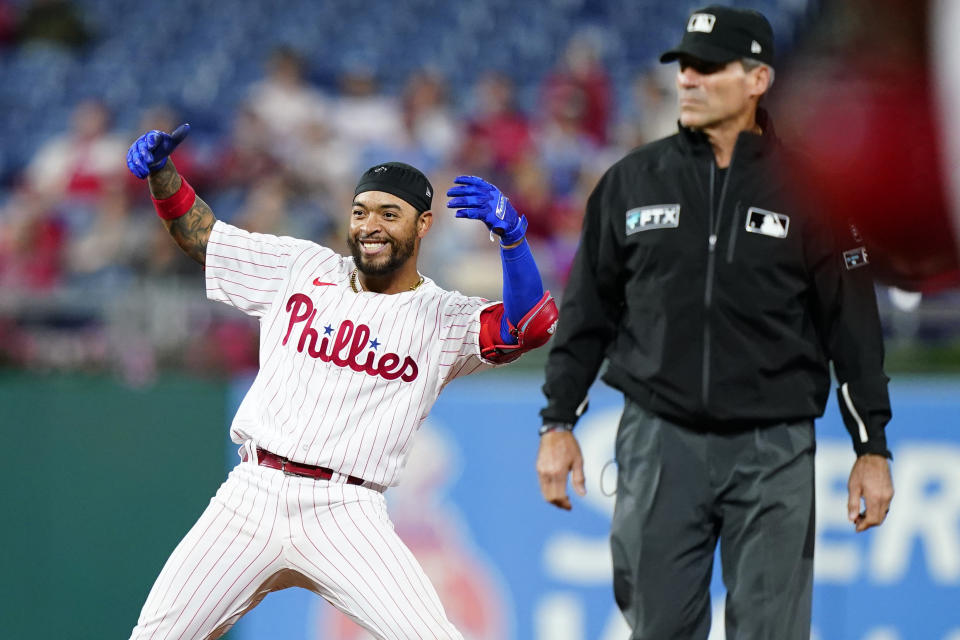 Philadelphia Phillies' Edmundo Sosa, left, reacts after hitting a run-scoring double against Miami Marlins pitcher Huascar Brazoban during the seventh inning of a baseball game, Wednesday, Sept. 7, 2022, in Philadelphia. (AP Photo/Matt Slocum)