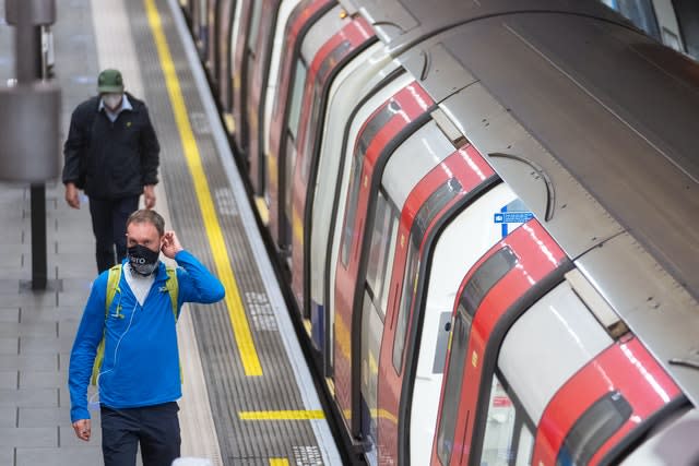 Commuters wearing protective face masks (Dominic Lipinski/PA)