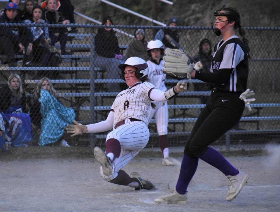 Canastota Raider Helen Shear (8) starts her slide into home plate during Wednesday's game in Little Falls against the Mounties.