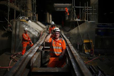Workers line up rails for the tunnelling machine at Crossrail's Stepney site in east London September 25, 2013. REUTERS/Andrew Winning
