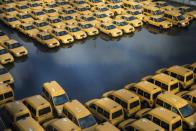 New taxi cabs are seen in a lot as flood waters recede on October 31 in Hoboken, New Jersey. The full extent of one of the largest and most destructive storms ever to strike the United States became clearer, with entire coastal communities in Maryland, Delaware and New Jersey submerged or cut off by floodwaters