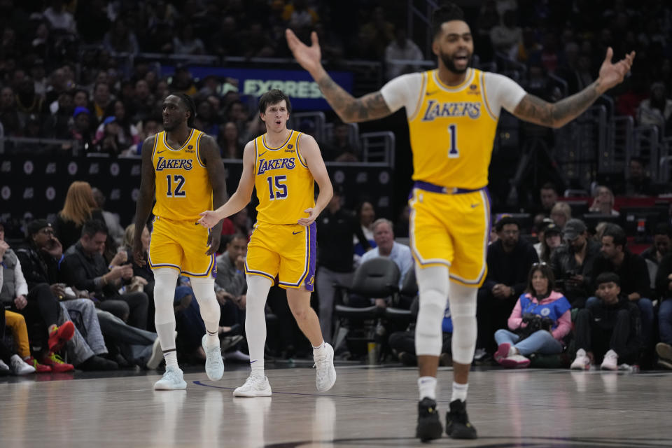 Los Angeles Lakers forward Taurean Prince (12), guard Austin Reaves (15) and guard D'Angelo Russell (1) react to a foul call during the second half of an NBA basketball game against the Los Angeles Clippers in Los Angeles, Tuesday, Jan. 23, 2024. (AP Photo/Ashley Landis)