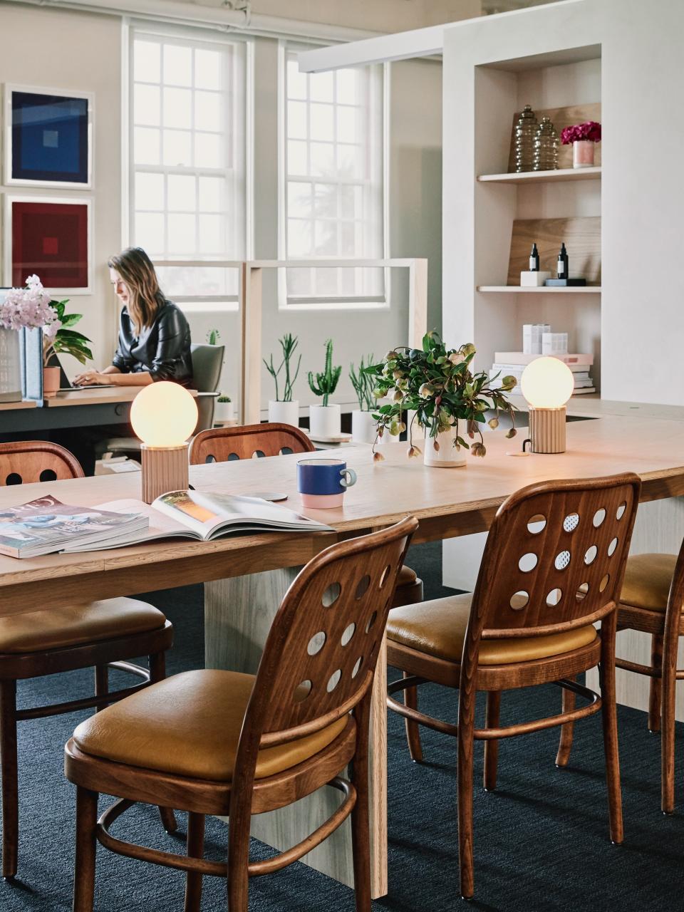 We’re big fans of the set of Joseph Hoffman chairs that replace your typical office seating. “I love the library space. I love the vintage chairs we found on Chairish. I love the table lights. I love seeing the company gather around that space,” says a fully enamored April.