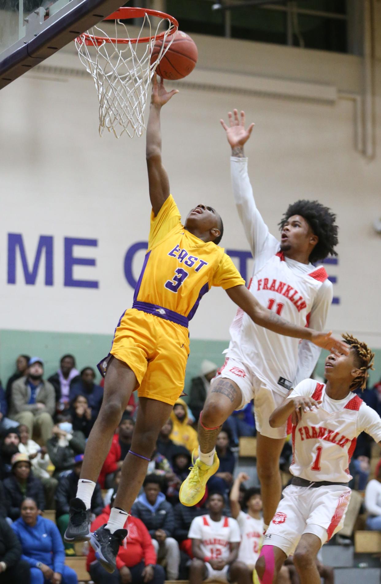 East guard Kesean Leonard drives in for two points ahead of the block attempt by Franklin's Kollin McCullough during their Section V matchup Friday, Jan. 5, 2024 at East High School.