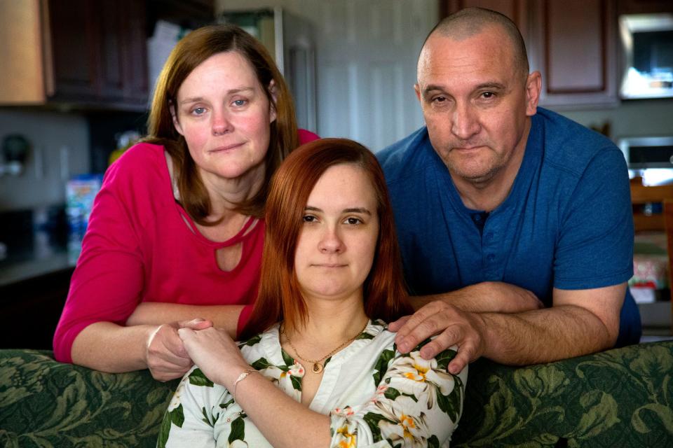 Caitlin Secrist, 21, and her parents Suzette and Bill