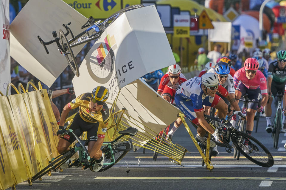 In this image released by World Press Photo, Thursday April 15, 2021, by Tomasz Markowski, titled Tour of Poland Cycling Crash, which won third prize in the Sports Singles category, shows Dutch cyclist, Dylan Groenewegen (left), crashes meters before the finish line, after colliding with fellow countryman Fabio Jakobsen during the first stage of the Tour of Poland, in Katowice, Poland, on August 5, 2020. (Tomasz Markowski, World Press Photo via AP)