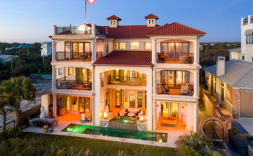 The three-story home includes six bedrooms, nine bathrooms, five balconies and a rooftop deck overlooking the beach.