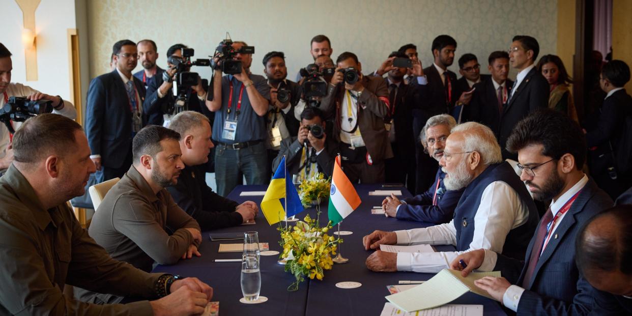 Ukrainian President Zelensky sits at a table with India Prime Minister Narendra Modi