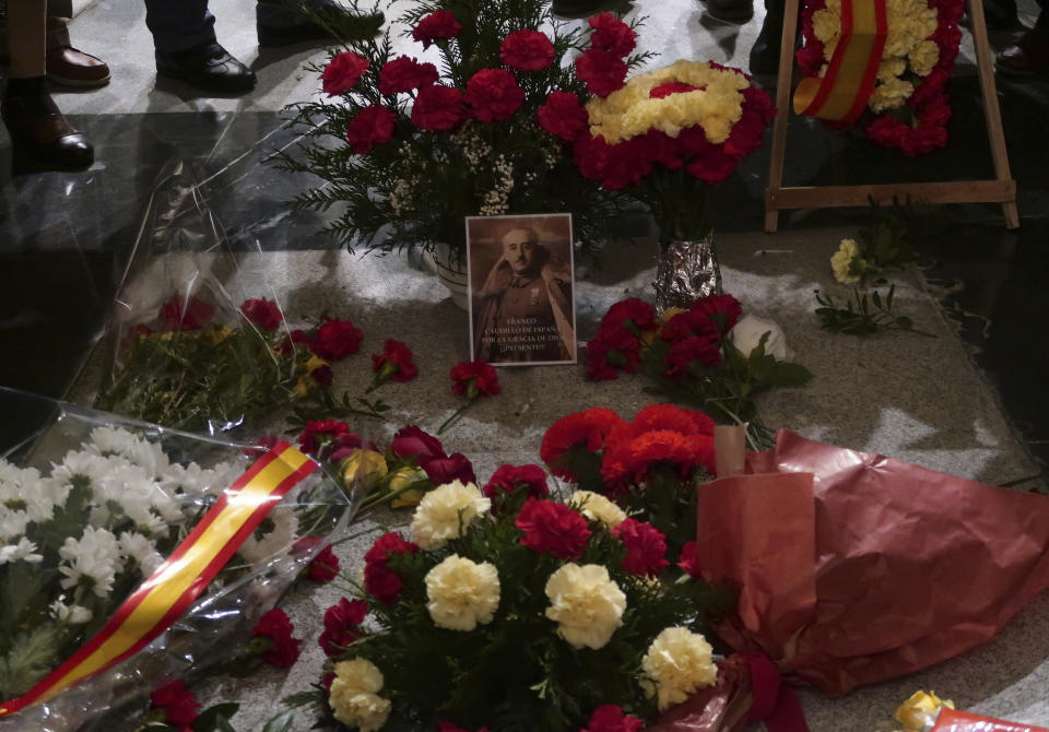 Flowers are placed on the tomb of former Spanish dictator Francisco Franco inside the basilica at the the Valley of the Fallen monument near El Escorial, outside Madrid, Tuesday, Nov. 20, 2018. Tuesday marks the 43rd anniversary of the death of Dictator Gen. Francisco Franco. (AP Photo/Manu Fernandez)