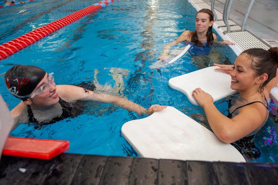Lily Kahrl, left, a Wellesley High School senior varsity swimmer, at practice at the Boston Sports Institute, Oct. 4, 2023. Lily, who has a rare genetic disorder, STXBP1 encephalopathy, competes in the 50-meter event, here with teammates Evie Murillo, right, and Kate Snow, center.
