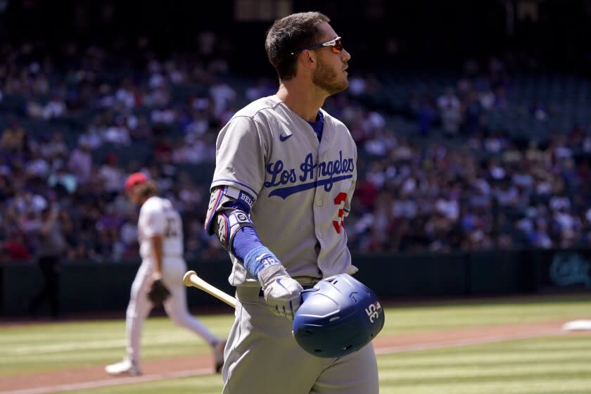 The Dodgers' Cody Bellinger walks to the dugout after striking out against the Diamondbacks