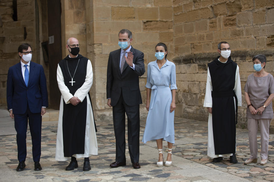 Spain's Health Minister Salvador Illa, left, Spain's King Felipe VI, third left, and Queen Letizia, third right, visit the Royal Monastery of Poblet, northeastern Spain, Monday, July 20, 2020. Hundreds of Catalan independence supporters are protesting Monday the visit of King Felipe VI and Queen Letizia to the northeastern region as part of a royal tour across Spain that is meant to bolster spirits amid the coronavirus pandemic. The visit comes as a barrage of media leaks have revealed how the king's father, former monarch Juan Carlos I, allegedly hid millions of untaxed euros in offshore funds. (David Zorrakino/Europa Press via AP)