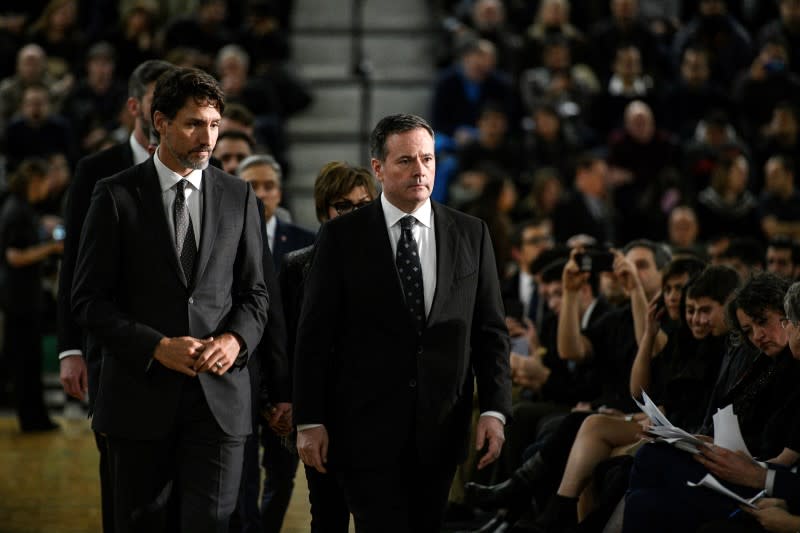 Mourners attend a service in memory of the victims of a Ukrainian passenger plane that crashed in Iran