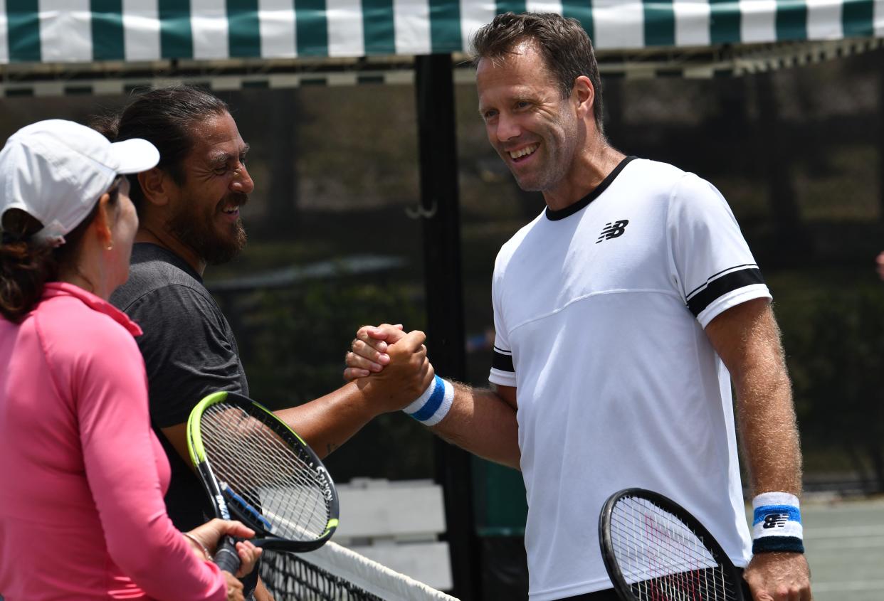 Tennis enthusiast Sue Bushman (left) joins former ATP pros Guillermo Canas (center) and Robert Lindstedt Saturday following a few volleys to raise money for First Serve USA in Palm Beach County.