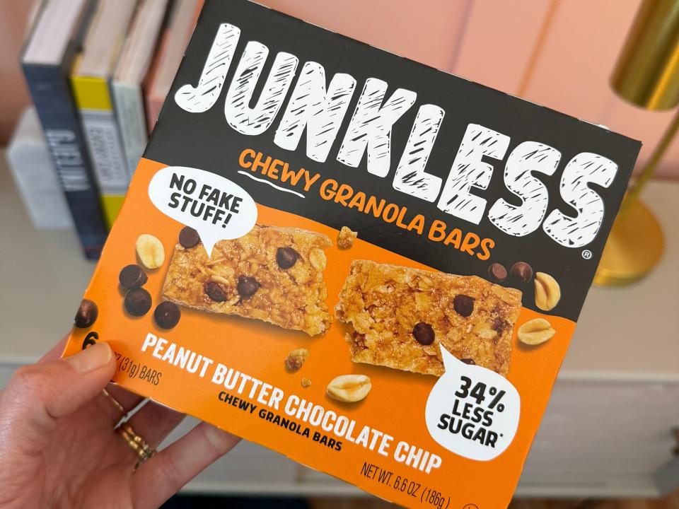 hand holding up a box of junkless granola bars