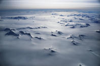 <p>Mountain peaks are seen from NASA’s Operation IceBridge research aircraft in the Antarctic Peninsula region, on Nov. 4, 2017, above Antarctica. (Photo: Mario Tama/Getty Images) </p>