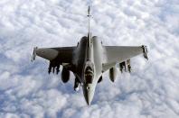 During a refuelling operation above the Mediterranean sea, a French Rafale fighter jet approaches an airborne Boeing C-135 refuelling tanker aircraft (not pictured), on March 30, 2011