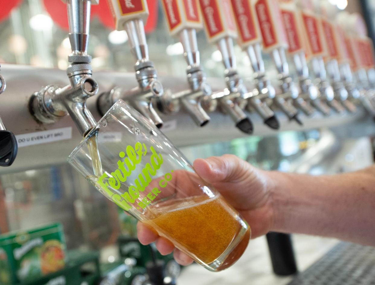 Fertile Ground Beer Campany bartender Josh Hall of Flowood pours a cold one for a patron at the Jackson brewery Thursday. Fertile Ground has been named to a Top 5 breweries in Mississippi list.