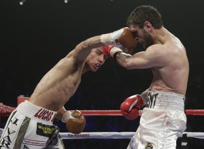 Jessie Vargas hits Khabib Allakhverdiev in the face during their WBA-IBO junior welterweight title boxing in April 2014. (AP Photo/Isaac Brekken)