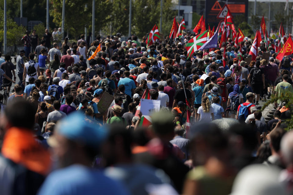 Anti-G-7 activists march from Hendaye, France, to Irun, Spain, during a protest Saturday, Aug. 24, 2019. World leaders and protesters are converging on the southern French resort town of Biarritz for the G-7 summit. President Donald Trump will join host French President Emmanuel Macron and the leaders of Britain, Germany, Japan, Canada and Italy for the annual summit in the nearby resort town of Biarritz. (AP Photo/Emilio Morenatti)