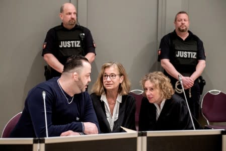 Niels Hoegel, accused of murdering 100 patients at the clinics in Delmenhorst and Oldenburg, speaks to his lawyer Ulrike Baumann during his trial in Oldenburg
