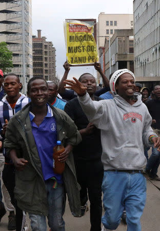 Zimbabweans take to the streets calling for President Robert Mugabe to step down, in Harare, Zimbabwe, November 18, 2017. REUTERS/Philimon Bulawayo