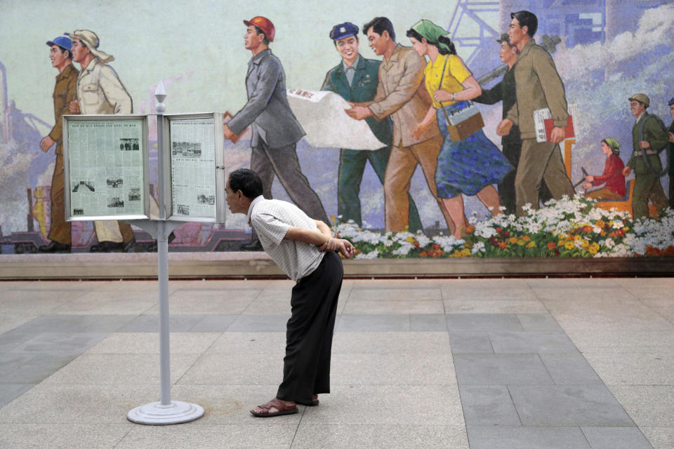 FILE - A man reads newspaper at a subway station in Pyongyang, North Korea, on Sept. 11, 2019. South Korea plans to lift its decades-long ban on public access to North Korean television, newspapers and other media as part of its efforts to promote mutual understanding between the rivals, officials said Friday, July 22, 2022, despite animosities over the North's recent missile tests. (AP Photo/Dita Alangkara, File)