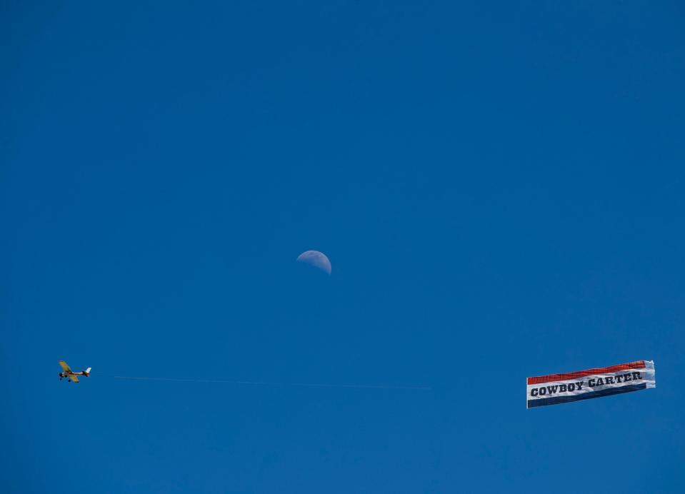 A "Cowboy Carter" banner is seen flying over the festival grounds during the Coachella Valley Music and Arts Festival in Indio, Calif., Sunday, April 14, 2024.