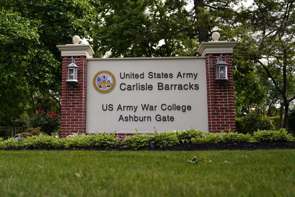 FILE - An entrance sign is seen outside the U.S. Army's Carlisle Barracks, June 10, 2022, in Carlisle, Pa. When two Native American boys from Nebraska died after being taken to the notorious boarding school hundreds of miles away in Pennsylvania, they were buried there without notice. Nearly 130 years later, the tribe wants the boys' remains back home. So far, the Army has refused to return the remains of Samuel Gilbert and Edward Hensley. (AP Photo/Matt Slocum, File)