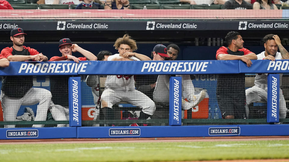 Members of the Cleveland Indians watch from the dugout in the ninth inning of a baseball game against the Minnesota Twins, Friday, May 21, 2021, in Cleveland. (AP Photo/Tony Dejak)