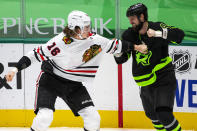 Chicago Blackhawks defenseman Nikita Zadorov (16) and Dallas Stars left wing Jamie Benn (14) fight during the second period of an NHL hockey game, Sunday, Feb. 7, 2021, in Dallas. (AP Photo/Sam Hodde)