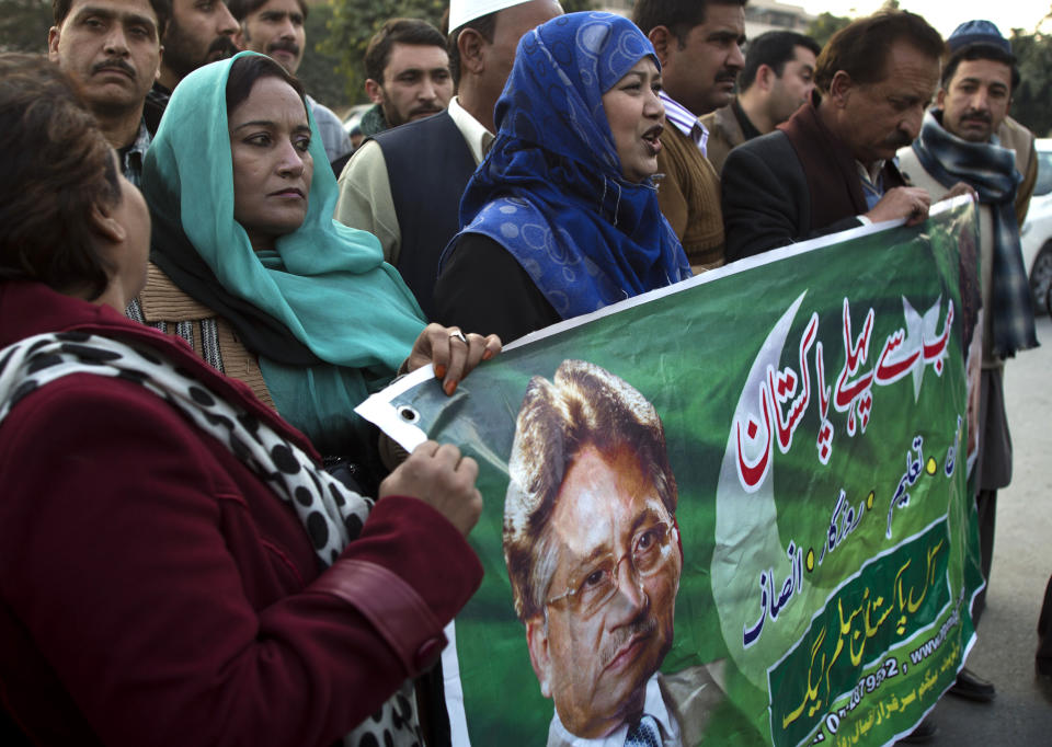 Supporters of Pakistan's former president and military ruler Pervez Musharraf stand outside a military hospital where Musharraf was admitted in Rawalpindi, Pakistan, Friday, Jan. 3, 2014. Musharraf was rushed to a hospital on Thursday with a heart problem he experienced while on his way to a court hearing in the high treason case, police and lawyers said. Writing on banner reads "first Pakistan." (AP Photo/B.K. Bangash)