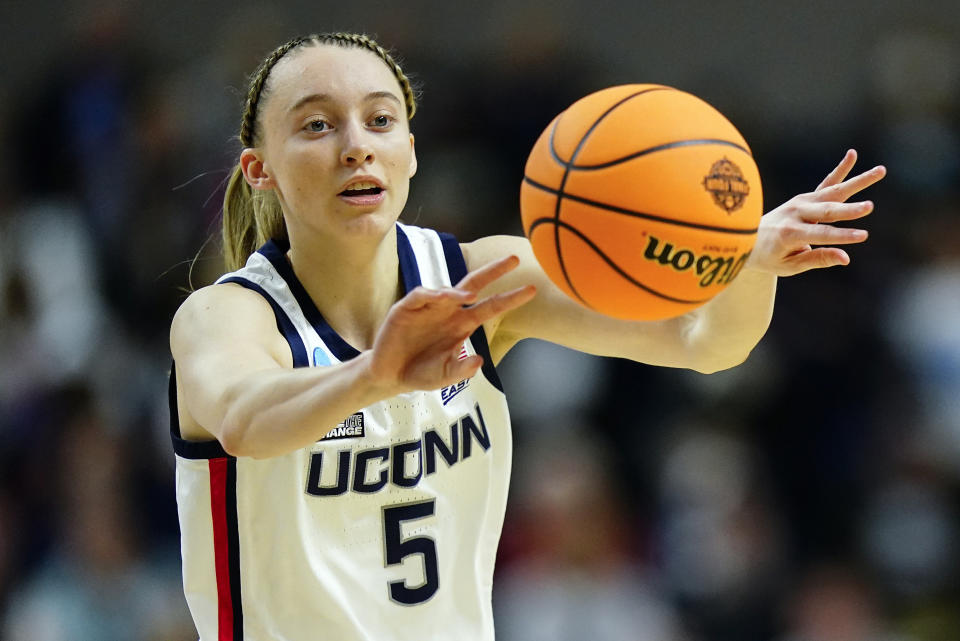 FILE - Connecticut guard Paige Bueckers (5) passes the ball during the first quarter of a college basketball game against Indiana in the Sweet Sixteen of the NCAA women's tournament, March 26, 2022, in Bridgeport, Conn. Bueckers was named to the preseason AP All-America women’s NCAA college basketball team, revealed Tuesday, Oct. 24, 2023. (AP Photo/Frank Franklin II, File)