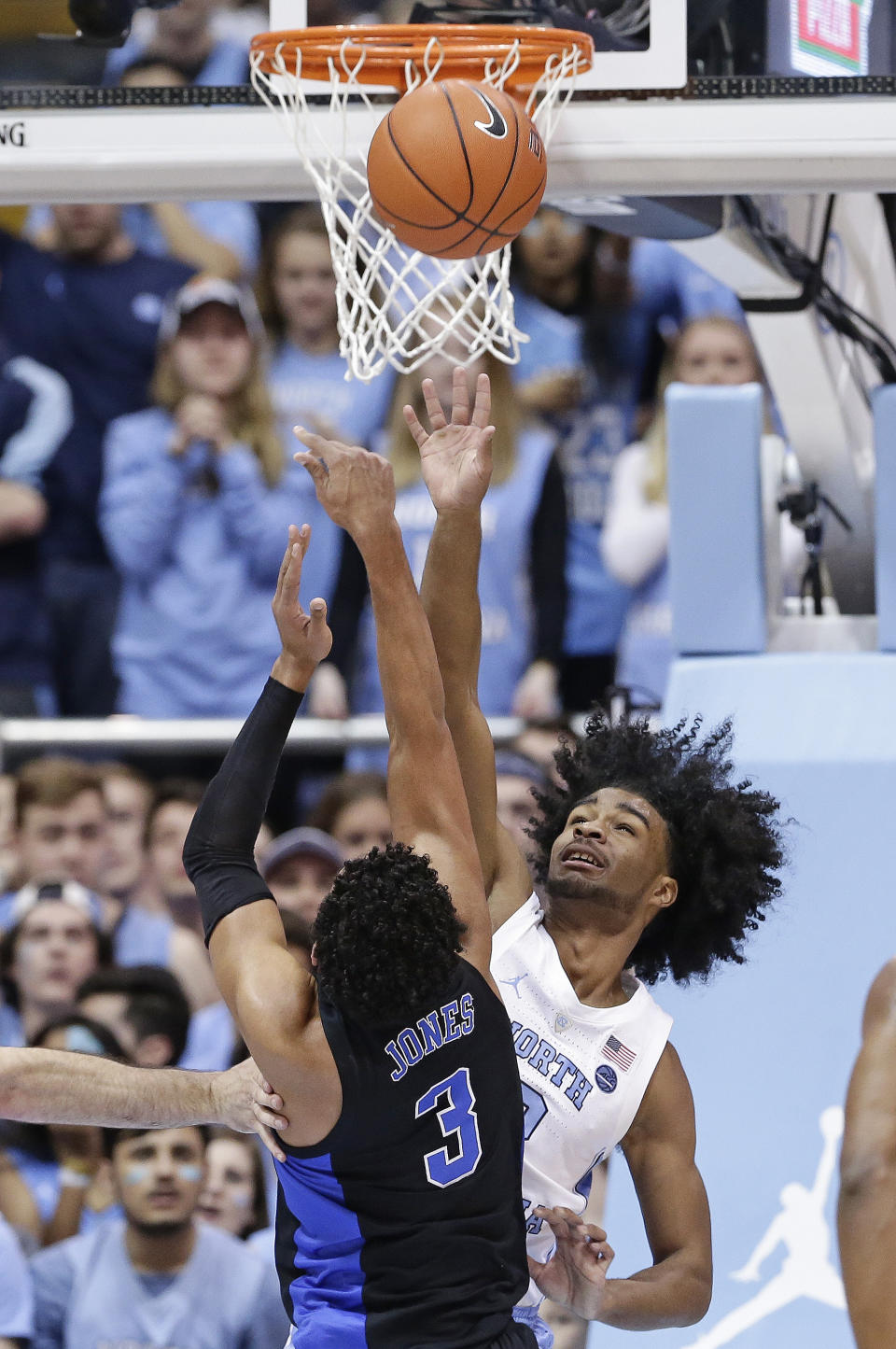 North Carolina's Coby White defends as Duke's Tre Jones (3) drives to the basket during the first half of an NCAA college basketball game in Chapel Hill, N.C., Saturday, March 9, 2019. (AP Photo/Gerry Broome)