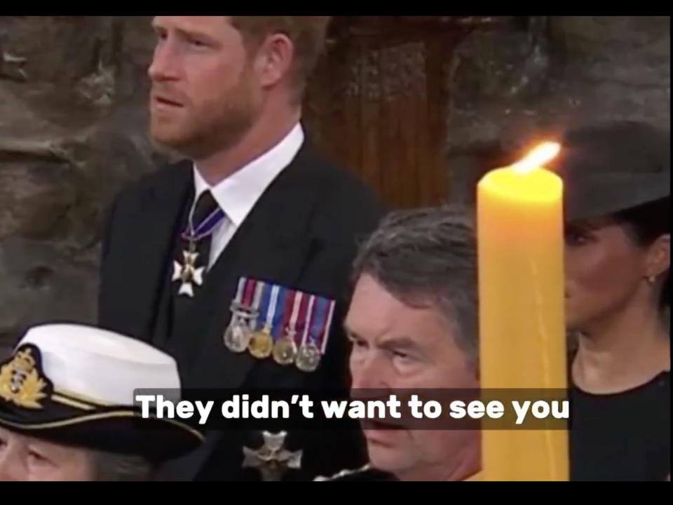 A screenshot of a video uploaded to Twitter showing a moment at the Queen's memorial where Meghan is blocked by a candle.