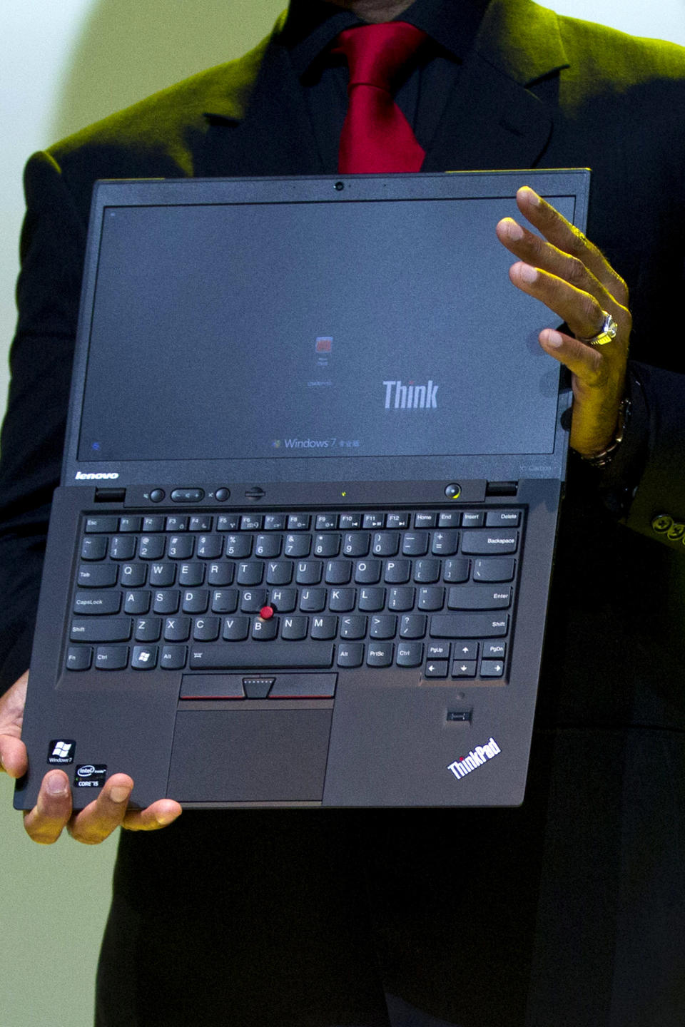 Lenovo Vice President Dilip Bhatia holds a new ThinkPad X1 Carbon laptop in Beijing Monday, Aug. 6, 2012. The Chinese computer maker unveiled the lighter, quicker ThinkPad notebook computer inspired by the convenience of tablets and smart phones. (AP Photo/Alexander F. Yuan)