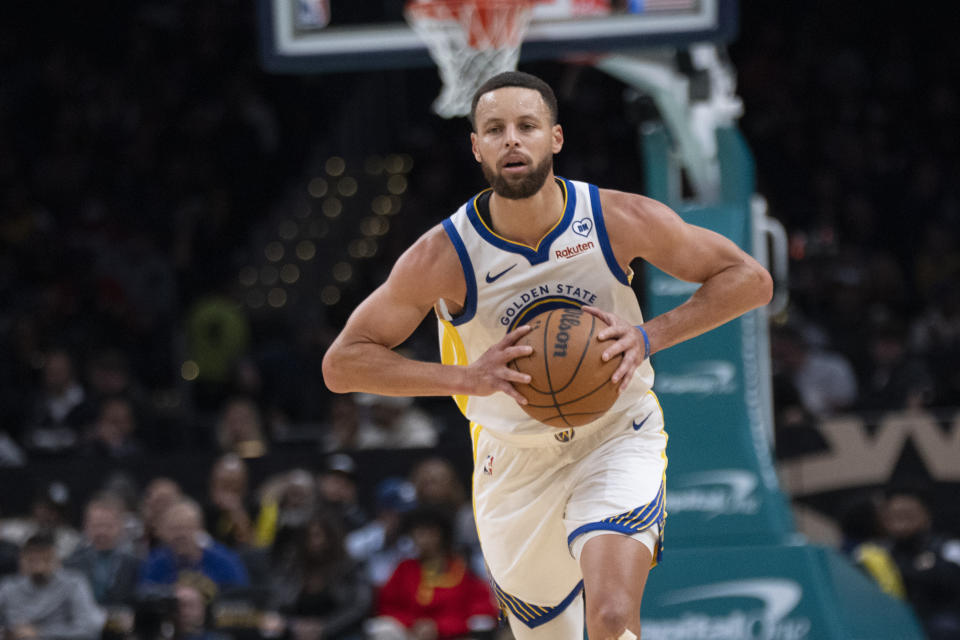 Golden State Warriors guard Stephen Curry (30) holds the ball to pass during the first half of an NBA basketball game against the Washington Wizards in Washington, Tuesday, Feb. 27, 2024. (AP Photo/Manuel Balce Ceneta)