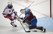 New York Rangers center Vincent Trocheck, left, loses control of the puck while trying to shoot against Colorado Avalanche goaltender Alexandar Georgiev, right, during the shootout of an NHL hockey game Friday, Dec. 9, 2022, in Denver. (AP Photo/David Zalubowski)